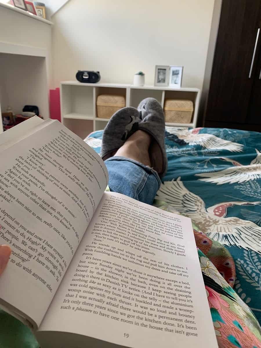 Reading a book in bed in the morning