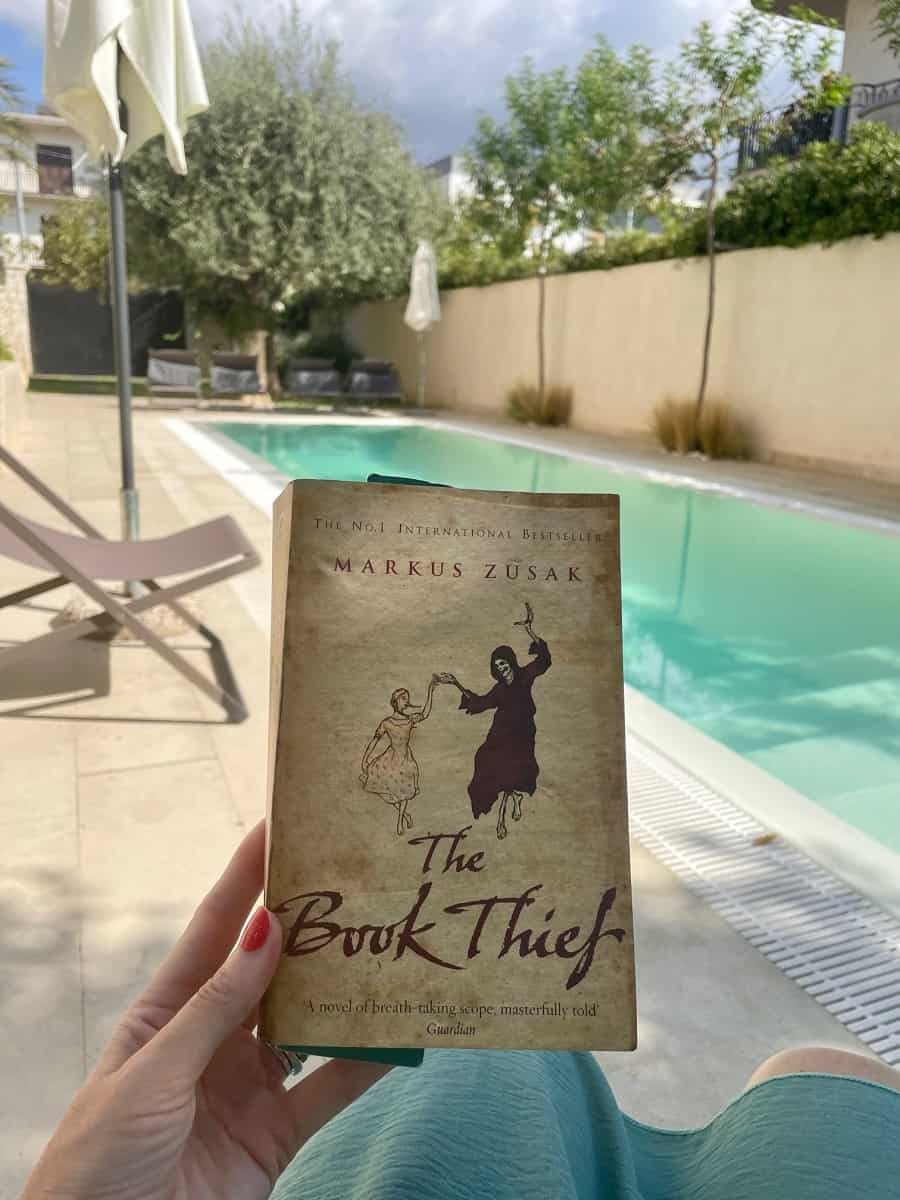 Reading The Book Thief by the pool