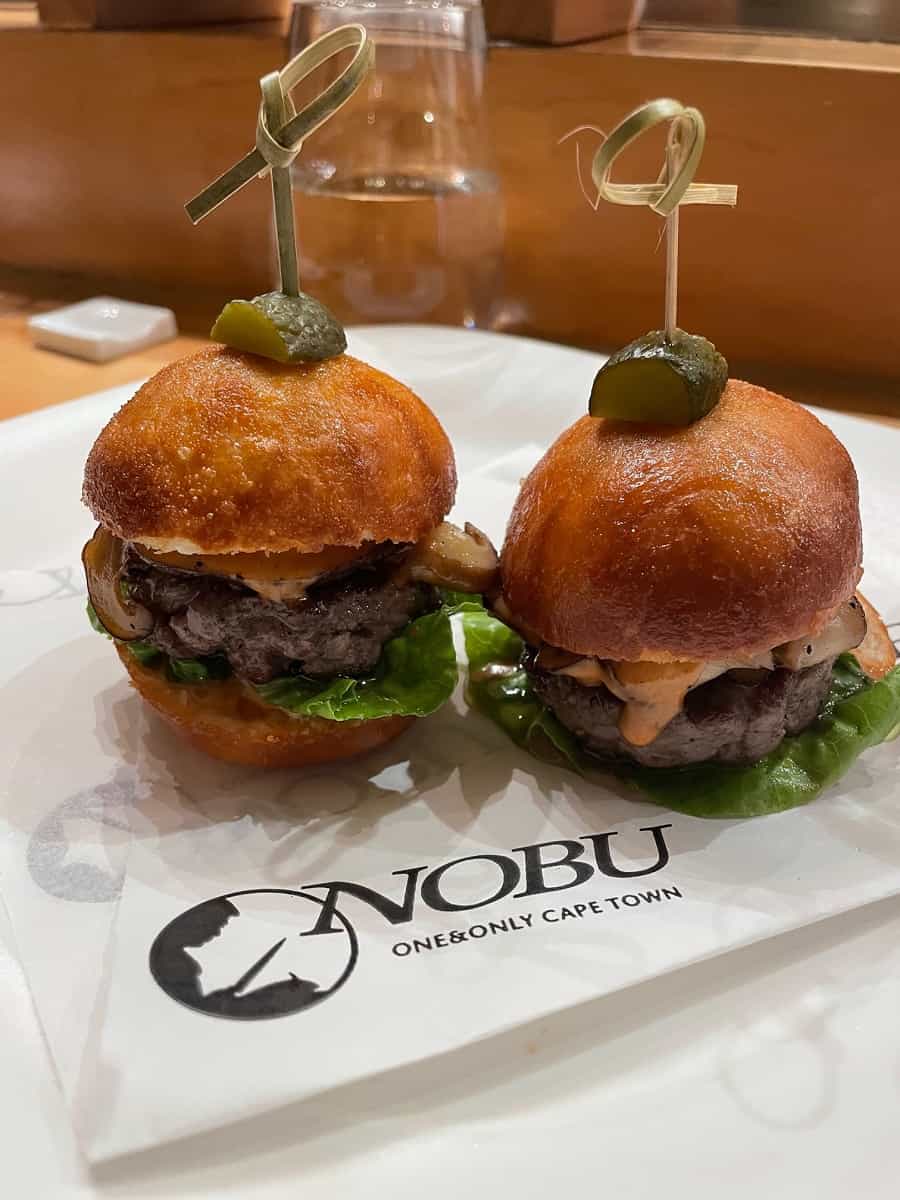 Wagu beef sliders on a plate with a serviette that says Nobu